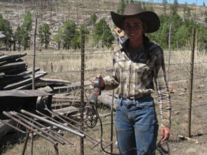 Holly Gibson Despain mending fence at the Black Canyon Ranch.