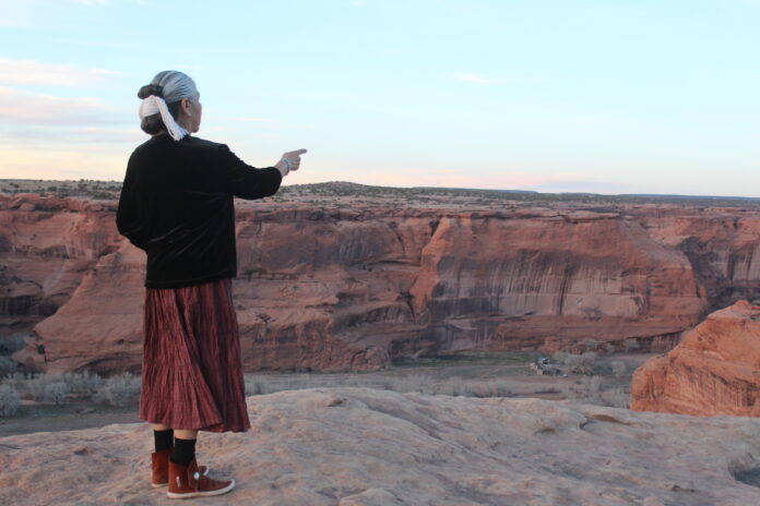 Canyon Keeper Lupita McCalahan shares the story of her family and the cultural significance of Canyon de Chelly. McCalahan speaks in Navajo about a Tribal member's home pictured in the bottom of the Canyon.